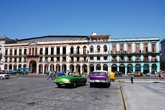 51 Cuba - Havana Centro - Old American Cars and colourful buildings across from Capitolio
